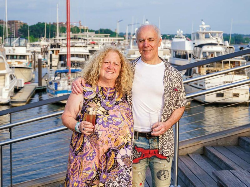 A couple standing in front of boats