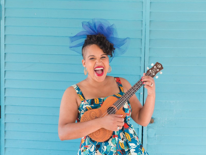 a singer with banjo and brightly colored dress