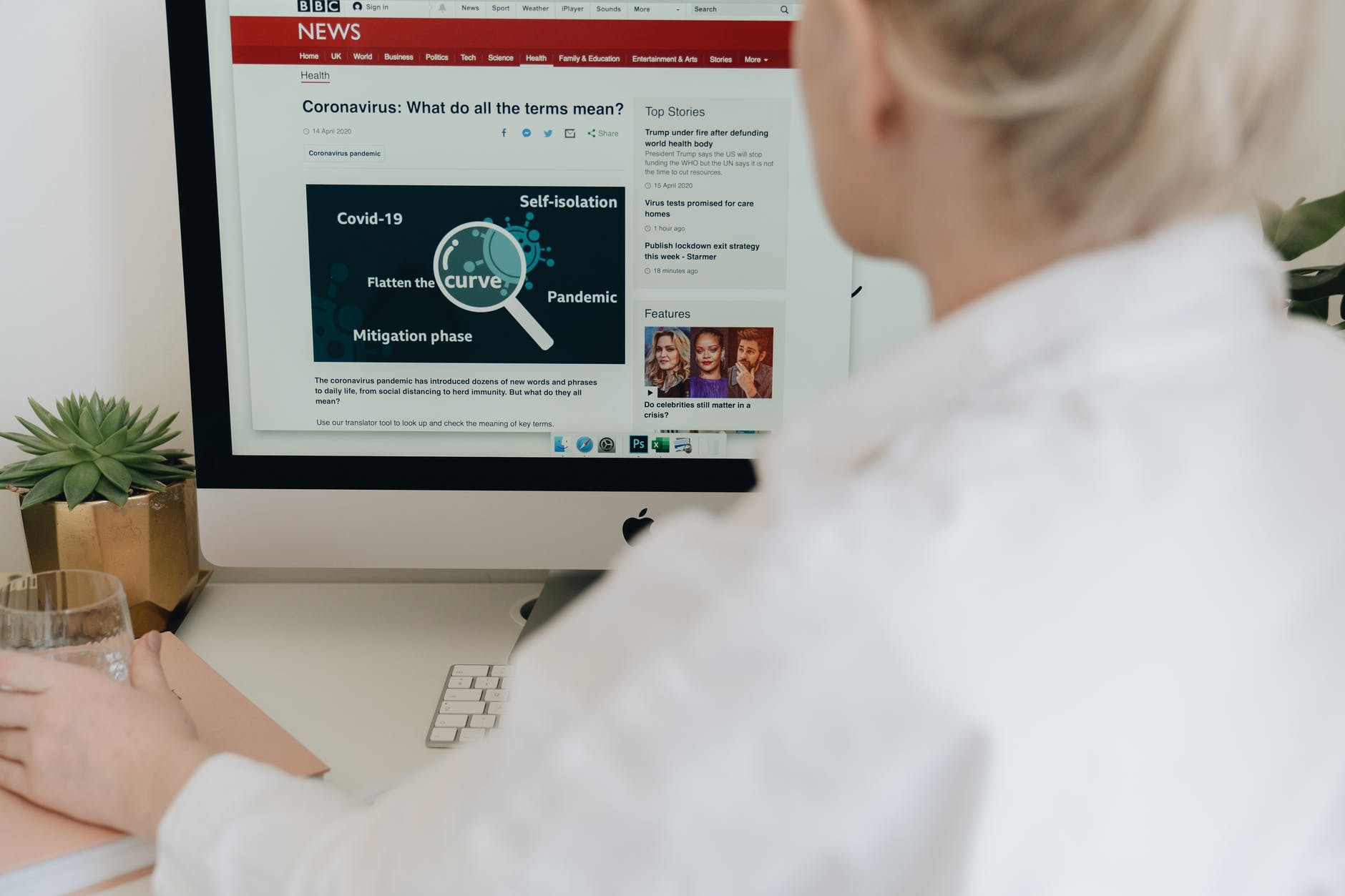 a woman using an imac computer