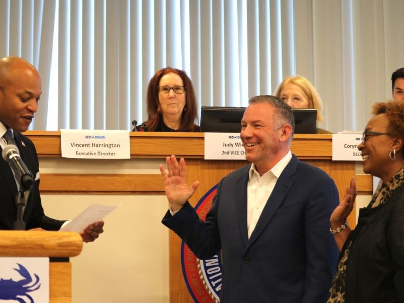 Maryland Gov. Wes Moore (D), left, reads the oath of office Nov. 18, 2023, for Ken Ulman, center, and Charlene Dukes, after they were elected as chair and first vice chair, respectively, of the Maryland Democratic Party.