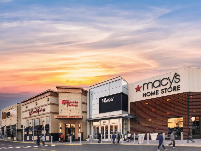 Photo of exterior of Westfield Montgomery mall with Macy's and Cheesecake Factory signs.