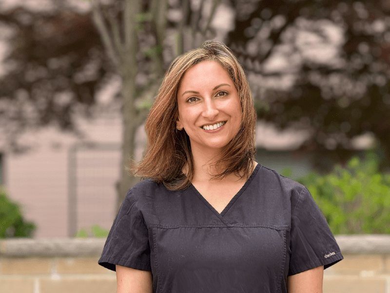 a smiling woman in scrubs